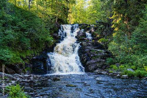 beautiful picturesque strong bubbling waterfall in the ruskeala mountain park in karelia in russia