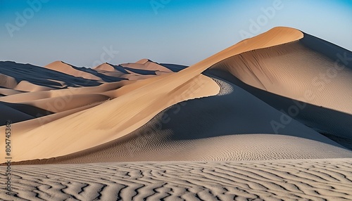 a closeup of a grey aeolian landform showcasing the intricate pattern of windsculpted peachcolored sand dunes the shadow adds depth to the landscape resembling a natural work of art