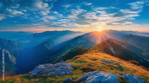 panoramic view of mountain landscape with sun in blue sky at sunrise