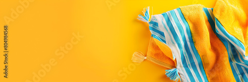 Bright beach towel clip web banner. Beach towel clip isolated on yellow background with copy space.