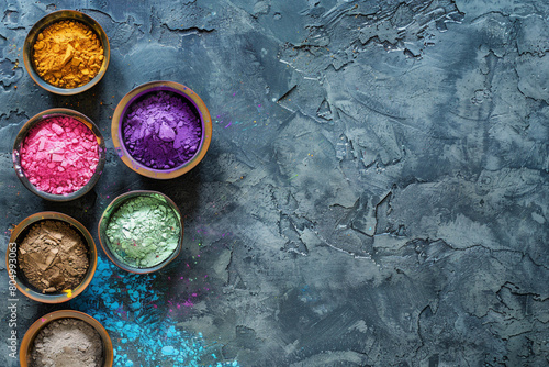 An overhead shot of Holi powder in bowls set on an ancient stone background symbolizing the tradition and heritage of the festival 