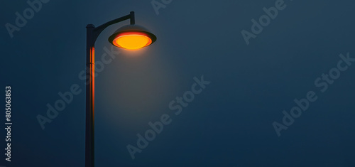 Orange light pole on the road with the blue night sky