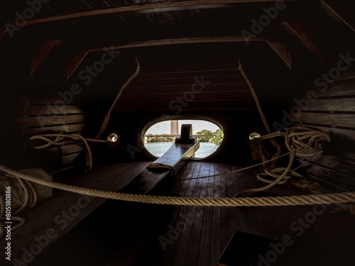 Interior of the stern area with the rudder for steering in the wooden replica carrack historical ship Nao Victoria of Magellan
