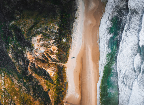 Aerial Drone view of The Pinnacles, Colored Sands on Fraser Island, Sunrise with car. Kgari, Queensland, Australia.