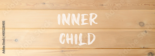 Inner child symbol. Concept words Inner child on beautiful wooden wall. Beautiful wooden wall background. Psychological, motivational inner child concept. Copy space.