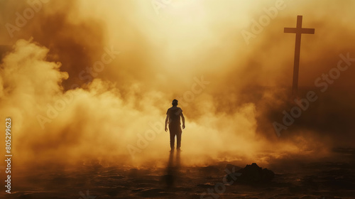 Silhouette of a man in the desert with a cross in the smoke and dust under light the sun, religion concept. 