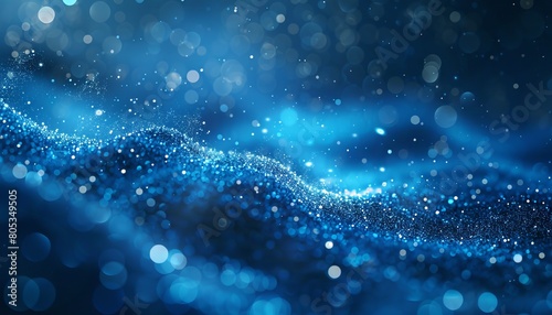 This image displays sparkling blue particles creating an abstract wave pattern on a dark background