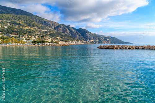 View from the plage des Sablettes beach at Menton, France, looking towards the Italian border and the Garavan port district and town of Ventimiglia, Italy. 