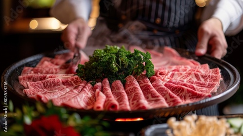 A chef presenting a platter of thinly sliced wagyu beef for shabu-shabu, tantalizing viewers with the promise of melt-in-your-mouth goodness.