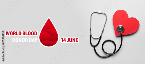 Stethoscope and red heart on light background. Cardiology concept