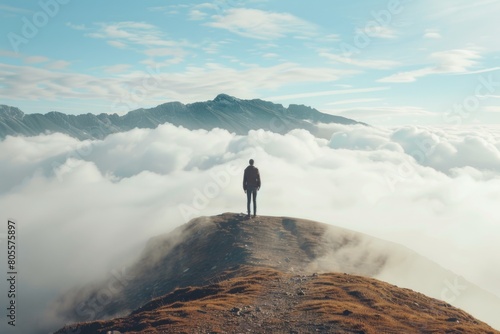 A person standing on a mountain top, suitable for outdoor and adventure themes