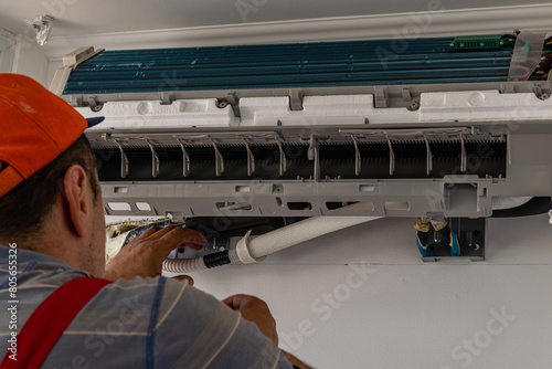 Electrician repairing air conditioner indoors Lviv Ukraine 08.04.24