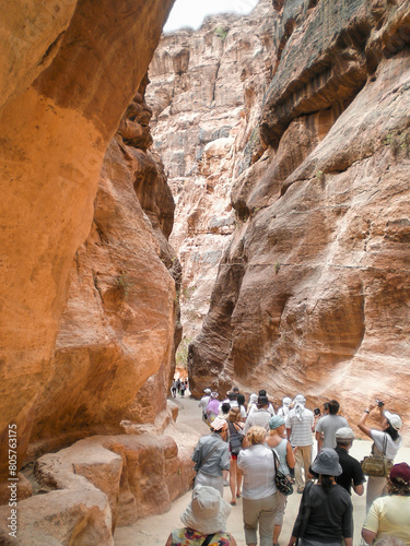 A large number of the tourists walk along the Al Siq gorge of the Petra historical reserve in the Wadi Musa city in Jordan
