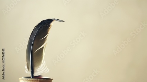 An antique, feather quill pen, its tip delicately poised above an inkwell, captured against a light, cream-colored solid background, invoking a sense of history and the art of writing. 