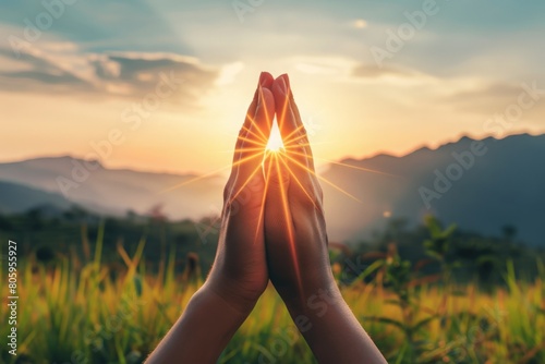 A person stands with outstretched arms, basking in the warm glow of the suns rays.