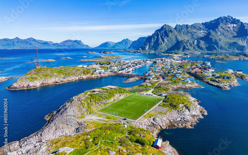The Henningsvaer football Stadion on an island in Lofoten, Norway. Iconic soccerfield on an island in the atlantic ocean. Aerial top down drone view.