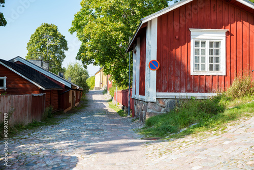 Porvoo, Finland. Narrow streets of Old town of Porvoo. Picturesque colorful wooden houses. Historic center, touristic place, landmark of Finland. Warm sunny summer day in nordic country.