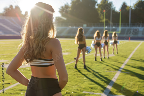 Group of cheerleaders in colorful uniforms standing on football field. Generative AI