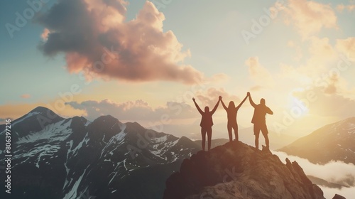 Together overcoming obstacles with three people holding hands up in the air on mountain top. We Made It. Celebrating success and achievements.