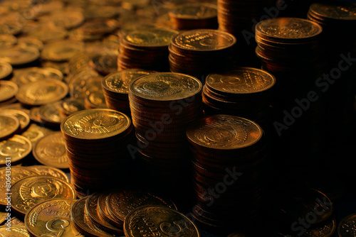 A large variety of coins on a black background. Stack of coins