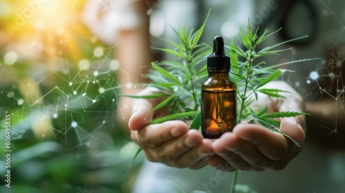 A person is holding a bottle of cannabis oil and a plant.