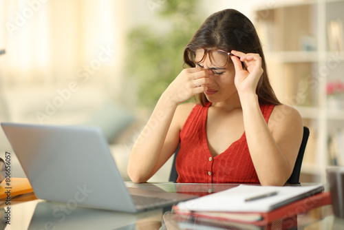 Student wearing eyeglasses suffering eyestrain