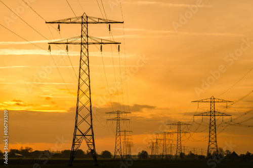 Power lines on a dutch landscape at the sunset.