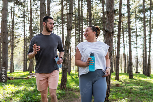 An inspiring scene unfolds as a beautiful, overweight female embarks on a jog in the park with her dedicated partner, embracing their journey to better health. 