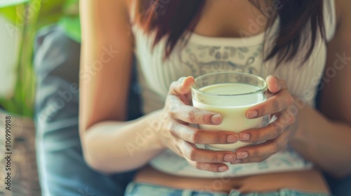 Lactose intolerance and Milk allergy concept. woman hold Milk glass and having abdominal cramps and pain when drink Cow Milk.