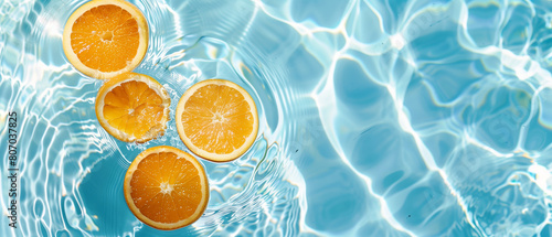 An artistic summer image displaying orange fruit slices in a pool of water. This captivating wallpaper captures the essence of summer and provides space for text.