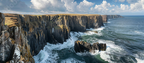 A breathtaking view of a rugged coastline, with cliffs plunging into the sea and waves crashing against the rocks below, the high-resolution image capturing the power and beauty of the ocean.