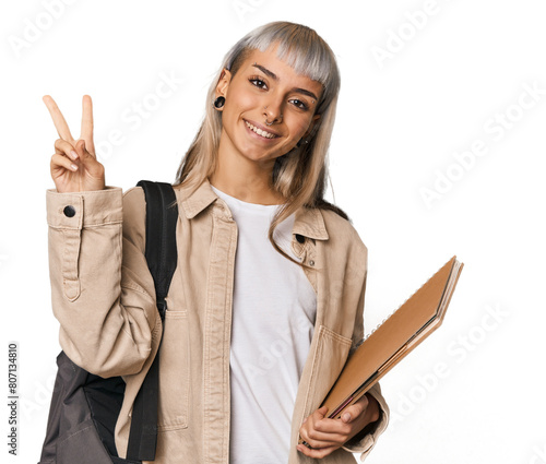 Caucasian young student with books showing number two with fingers.