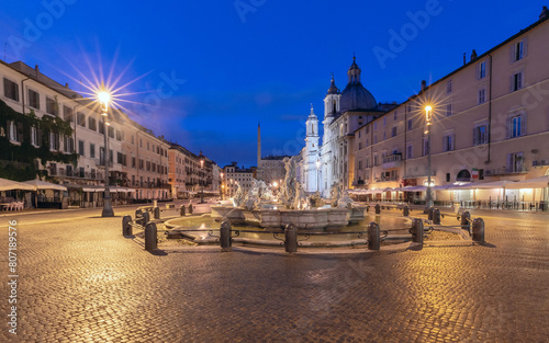 The famous fountains with tritons in Piazza Navona in Rome at dawn.