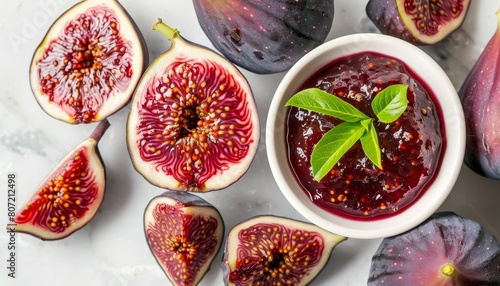 Fresh figs and homemade fig jam on a marble table