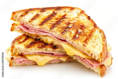 Grilled ham and cheese sandwich on white surface