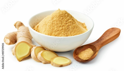 Ground ginger powder and sliced rhizomes in white bowl with wooden spoon on white background