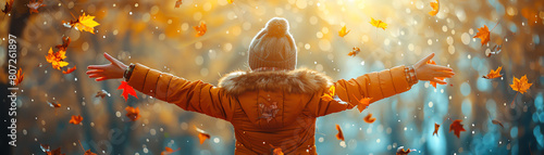 Woman joyfully tossing autumn leaves, orange and teal color grading highlights the seasonal cheer