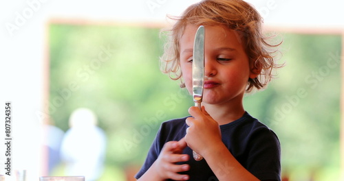 Little boy playing with knife mother removes dangerous knife from hand