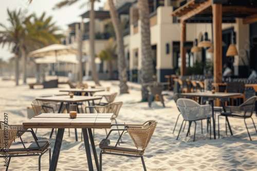 Beachfront cafe setup with modern tables and chairs on sandy beach, surrounded by palm trees