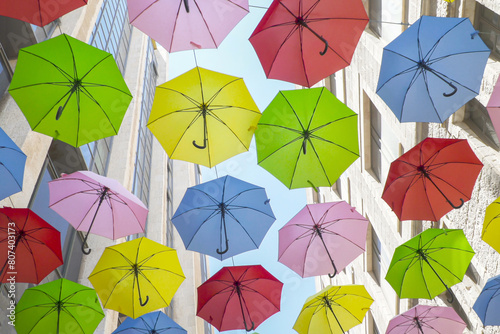 street in Jerusalem, Israel, adorned with multi-colored umbrellas, creating a fest picturesque scene for pedestrians.