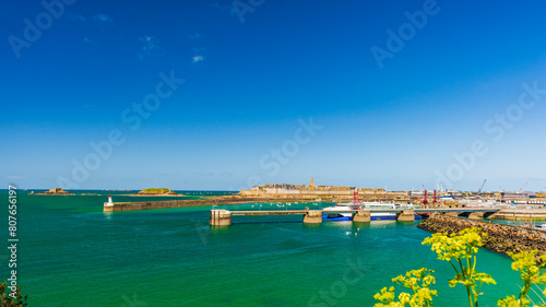 Panorama of Saint-Malo, the Breton corsair city. Seen from the ramparts and the port entrance, under a blue sky.