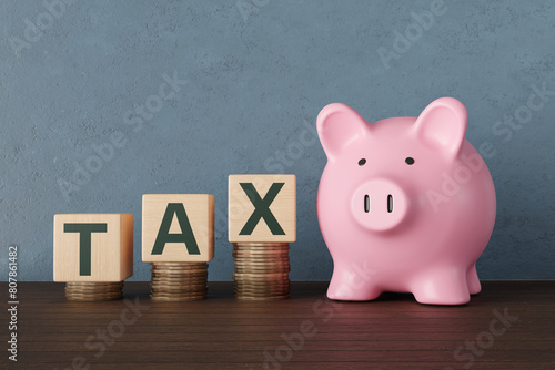 Pink piggy bank standing next to wooden toy blocks showing the word TAX on stacks of gold coins. Illustration of the concept of taxation, tariff, income tax and capital gain tax 