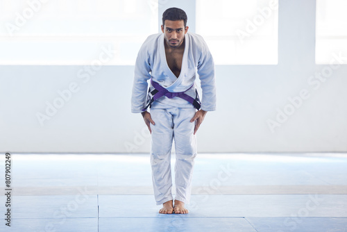 Man, bow and respect in karate for sport in fitness center for self defense, fighting and discipline. Pro athlete, champion and ready to fight with martial arts, practice and wellness for competition