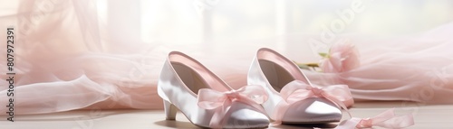 A pair of ballet slippers, delicate and pink, placed gracefully against a soft, light background, offering elegance and artistry.