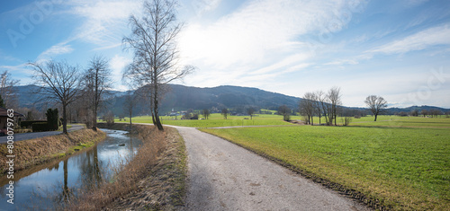 walkway along Jenbach river, view to Auer Weitmoos landscape, near Bad Feilnbach