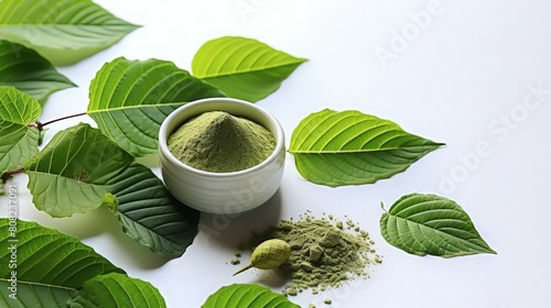 Kratom leaves and powder on white background. Mitragyna speciosa, a tropical evergreen tree in the coffee family native to Southeast Asia.