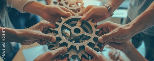 Group of business people hands putting gears together. Teamwork concept