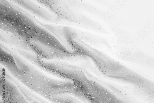 A white fabric with a pattern of snowflakes and a few other small shapes. The snowflakes are scattered all over the fabric, giving it a wintery and cozy feel