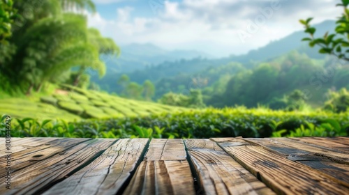 close-up Wooden table in front of a view of a tea plantation with mountains in the background