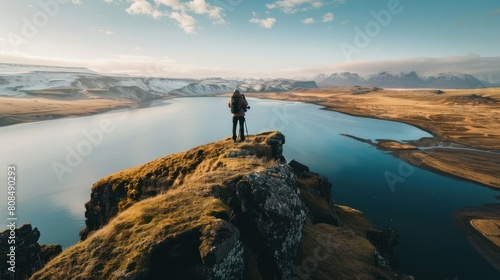 drone photographer capturing aerial footage of a breathtaking landscape scene.,